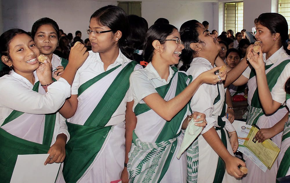 Students celebrate their success in the West Bengal Board of Higher Secondary Educations class 12th Examination after the result were declared at Balurghat in South Dinajpur district of West Bengal.