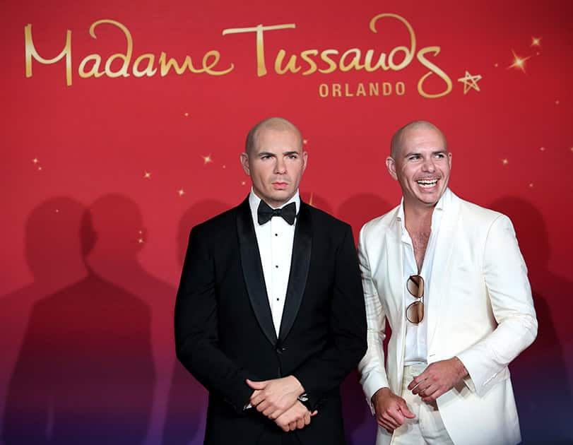 Rapper Pitbull laughs after his wax double is revealed at Madame Tussouds Orlando Wax Musuem in Orlando, Fla.