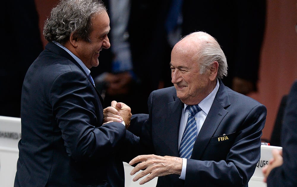 Re-elected FIFA president Sepp Blatter is congratulated by FIFA vice president and UEFA president Michel Platini after his speech during the 65th FIFA Congress held at the Hallenstadion in Zurich, Switzerland.