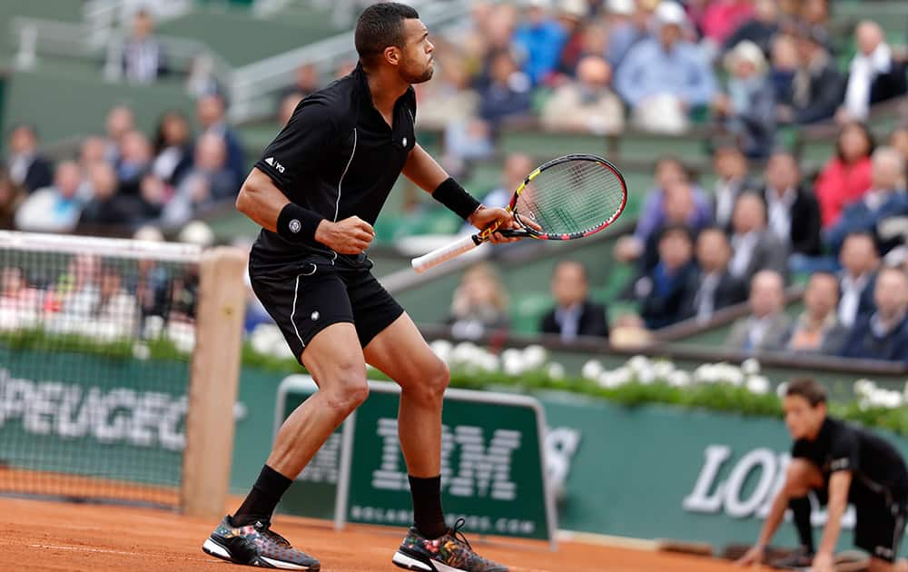 France's Jo-Wilfried Tsonga clenches his fist after scoring a point in his third round match of the French Open tennis tournament against Spain's Pablo Andujar at the Roland Garros stadium, in Paris, France.