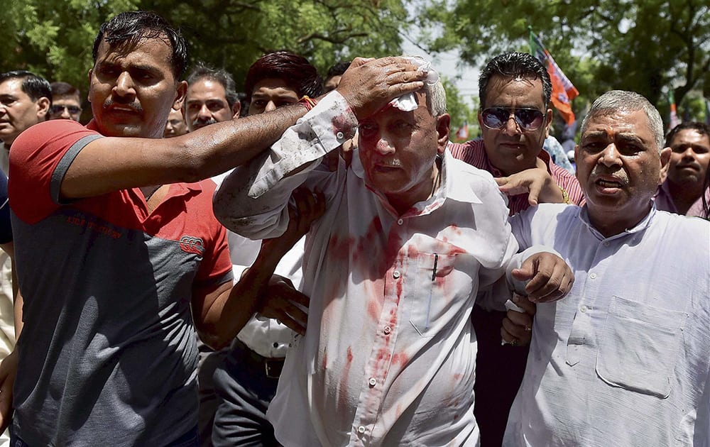 A BJP workers gets injured by water cannon during a protest outside Delhi CM Arvind Kejriwals residence in New Delhi on Saturday after reports regarding the Delhi governments plan to buy snooping equipments for its Anti-Corruption Branch.