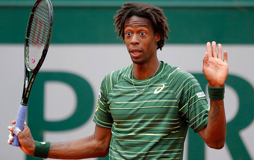 France's Gael Monfils gestures in his third round match of the French Open tennis tournament against Uruguay's Pablo Cuevas at the Roland Garros stadium, in Paris