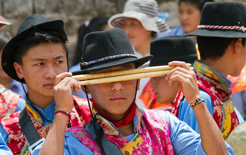 Exile Tibetan students in traditional attire prepare to play in the school band during the opening ceremony of the Gyalyum Chemo Memorial Gold Cup soccer tournament at the Tibetan Children's Village School in Dharmsala, India.