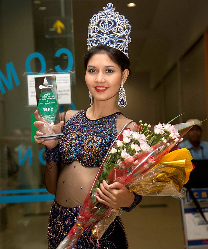 Myanmar model Zun Than Zin poses for photos upon her arrival at Yangon International airport in Yangon, Myanmar, after winning the Luxury Brand Model Awards held in South Korea.