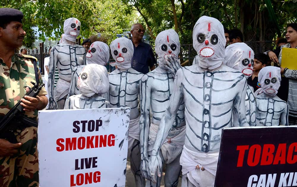 People dressed up as skeletons participate in a social awareness campaign on World No Tobacco Day in Kolkata.