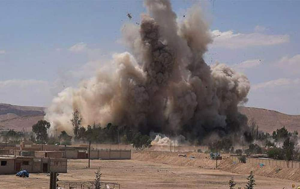 smoke rises at Tadmur prison after being blown up and destroyed by the Islamic State group at Palmyra Town, in Homs province, Syria.