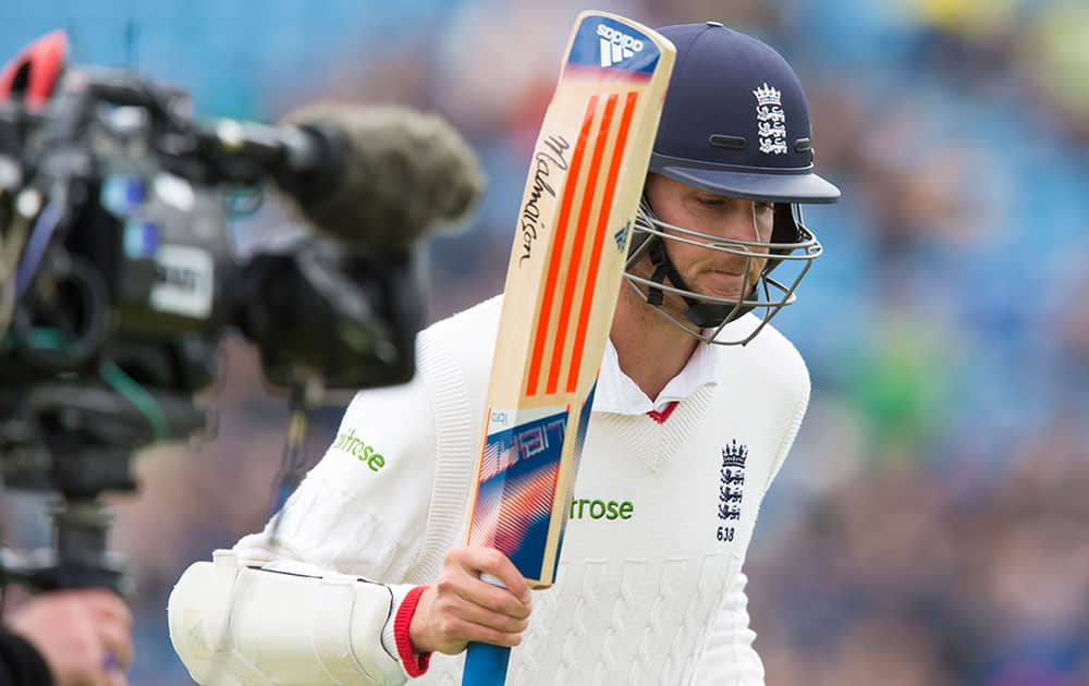 England's Stuart Broad raises his bat as he walks from the pitch after being bowled by New Zealand's Matt Henry for 46 on the third day of the second Test match between England and New Zealand at Headingley cricket ground in Leeds, England.