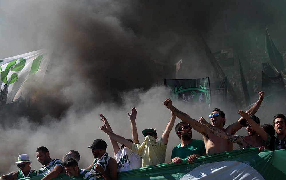 Sporting supporters cheer during the Portugal Cup final match between Sporting and Braga at the National stadium, in Oeiras, near Lisbon, Portugal.