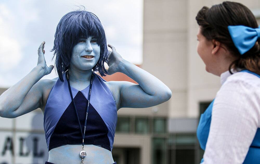 Two women discuss their costuming plans at the MomoCon anime, gaming and comic book fan convention, in Atlanta.