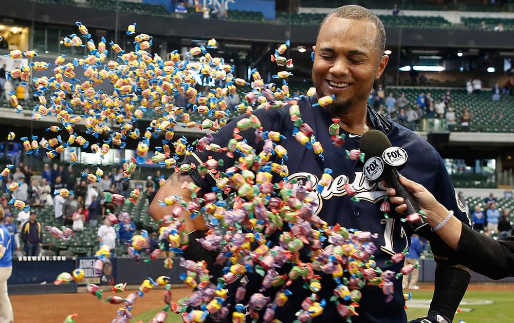 Milwaukee Brewers' Martin Maldonado is showered with bubble gum during a post game interview after their 7-6 victory against the Arizona Diamondbacks in a 17 inning baseball game, in Milwaukee.