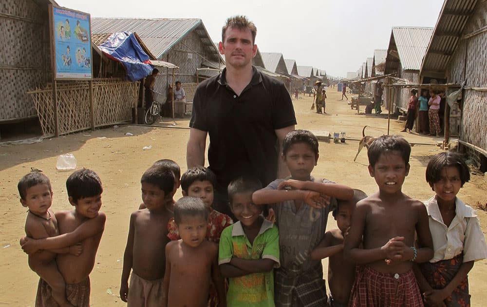 American actor Matt Dillon poses with Rohingiya children at a camp for refugees, north of Sittwe in the western state of Rakhine, Myanmar.