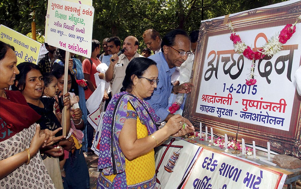 Members of the Consumer Protection and Action Ccommittee observe death anniversary of “Achchhe Din” during a protest against hike in service tax in Ahmedabad.