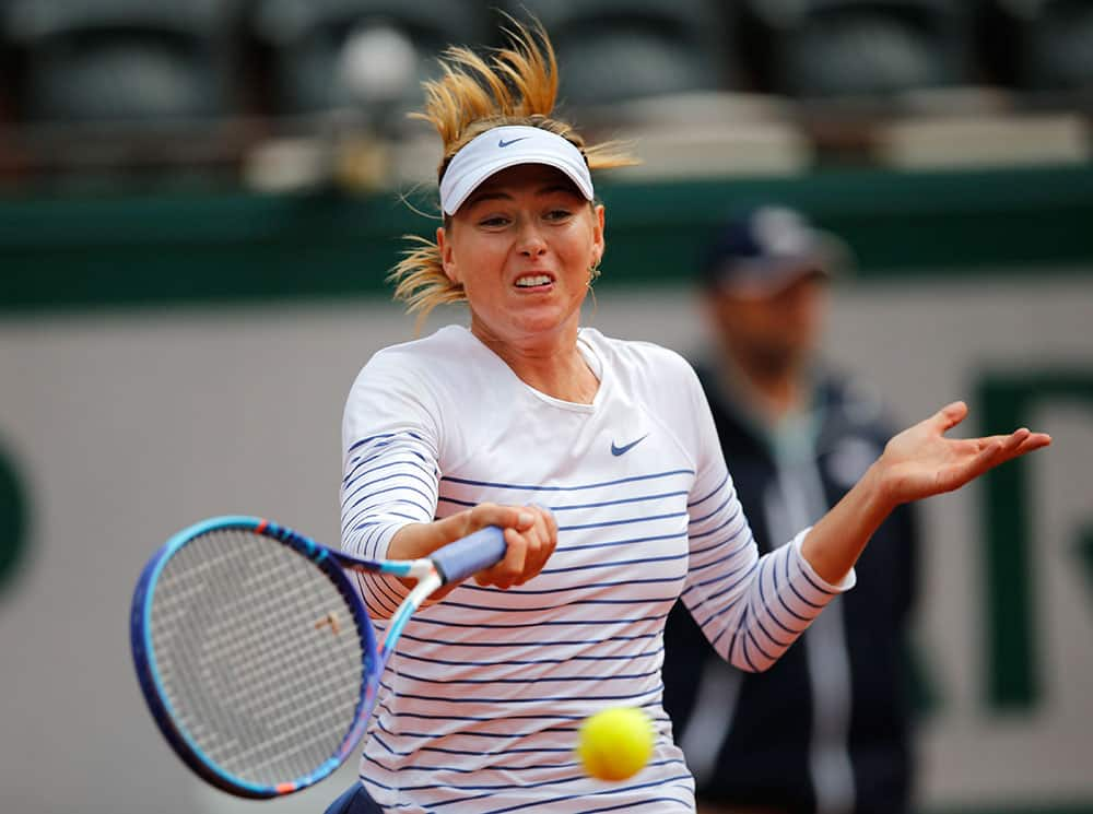 Russia's Maria Sharapova serves the ball to Lucie Safarova of the Czech Republic during their fourth round match of the French Open tennis tournament at the Roland Garros stadium.