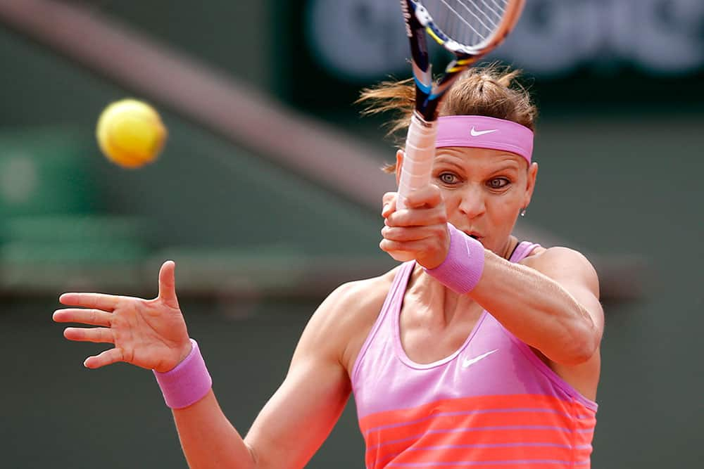 Lucie Safarova of the Czech Republic returns the ball to Russia's Maria Sharapova during their fourth round match of the French Open tennis tournament at the Roland Garros stadium.