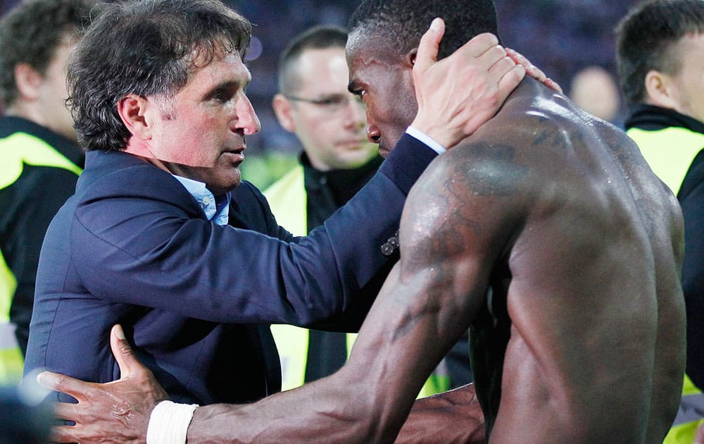 Hamburg's head coach Bruno Labbadia, left, and Hamburg's Johan Djourou from Switzerland celebrate after the second leg relegation Bundesliga soccer match between Karlsruher SC and Hamburger SV in Karlsruhe, Germany.