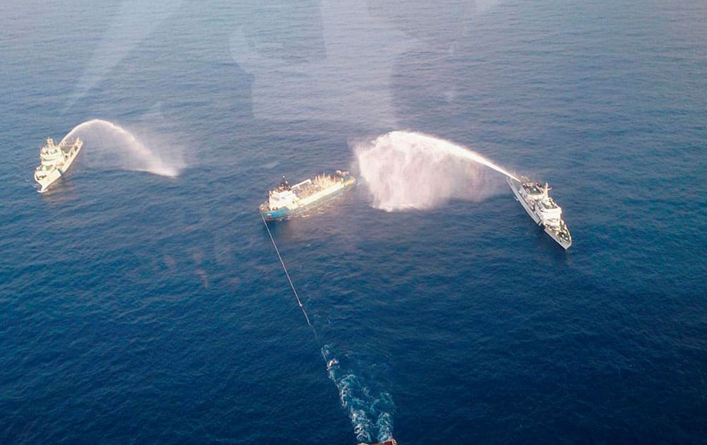 Mumbai: The Coast Guard men dousing the fire that broke out at an ONGC supply vessel.