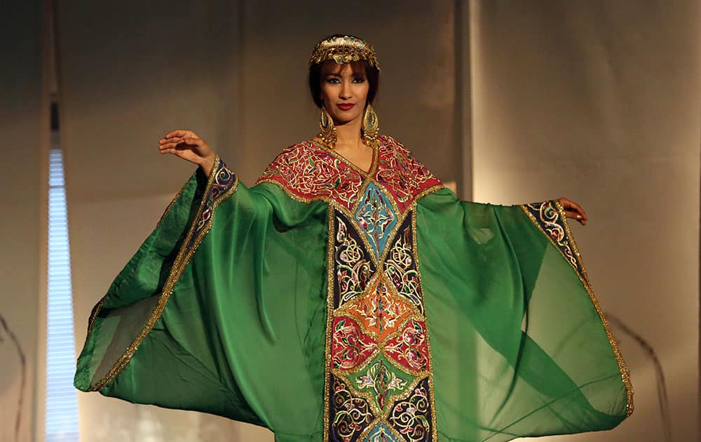 A model wearing a traditional Iraqi folk costume dances on the opening day of an annual folk fashion show event in Baghdad.