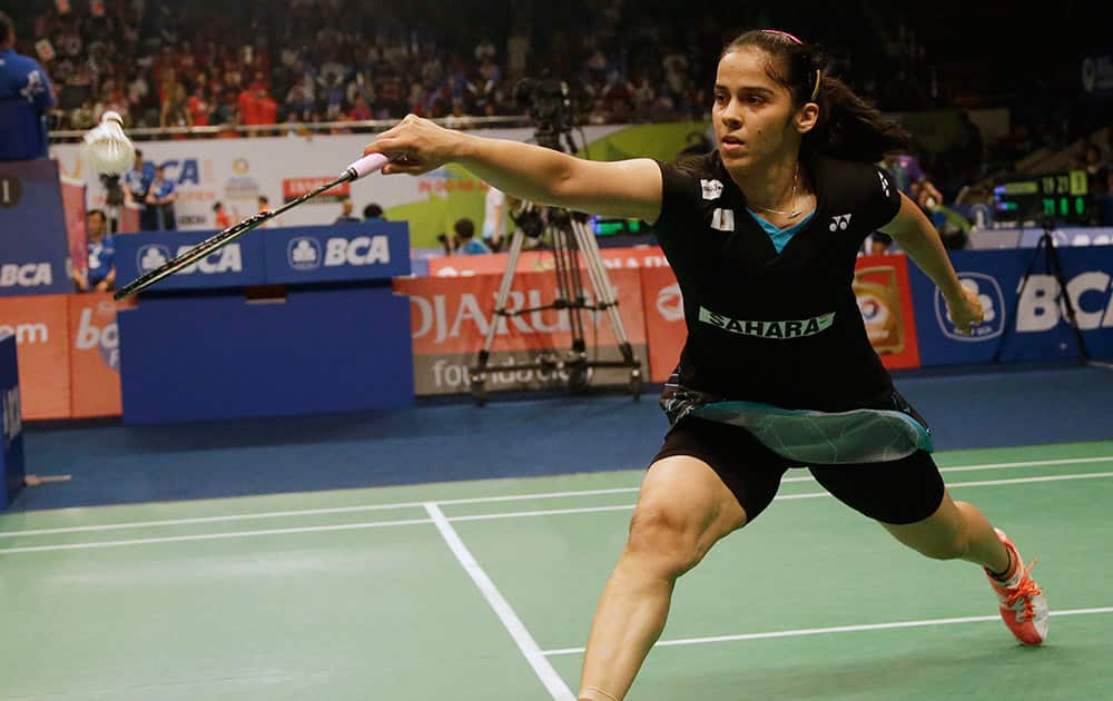 Saina Nehwal makes a backhand return during her qualifying match at the Indonesia Open badminton tournament at Istora Stadium in Jakarta, Indonesia.