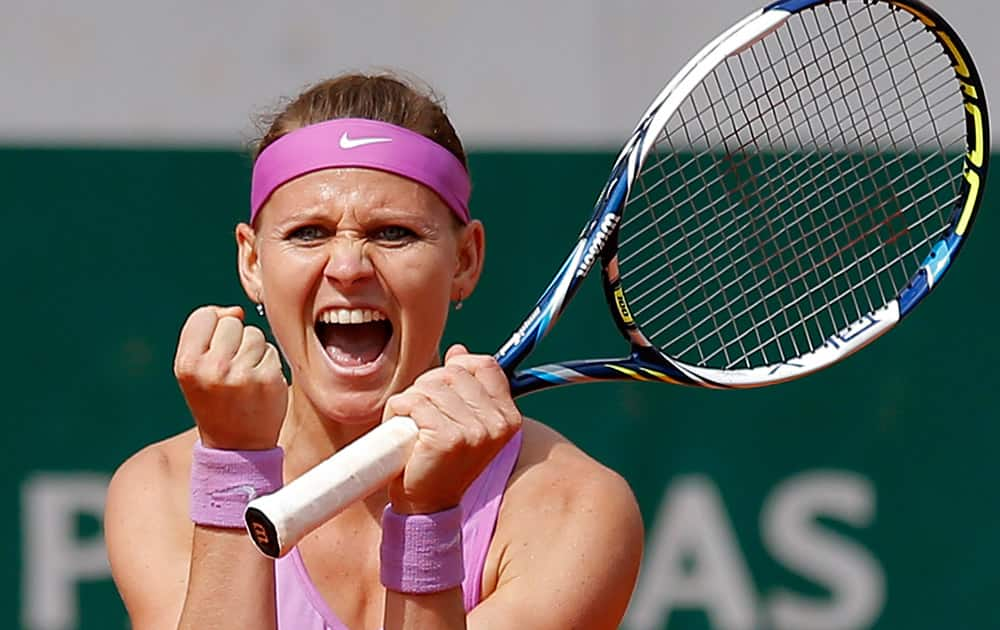 Lucie Safarova of the Czech Republic celebrates winning the quarterfinal match of the French Open tennis tournament against Spain's Garbine Muguruza in two sets, 7-6 (7-3), 6-3, at the Roland Garros stadium, in Paris, France.