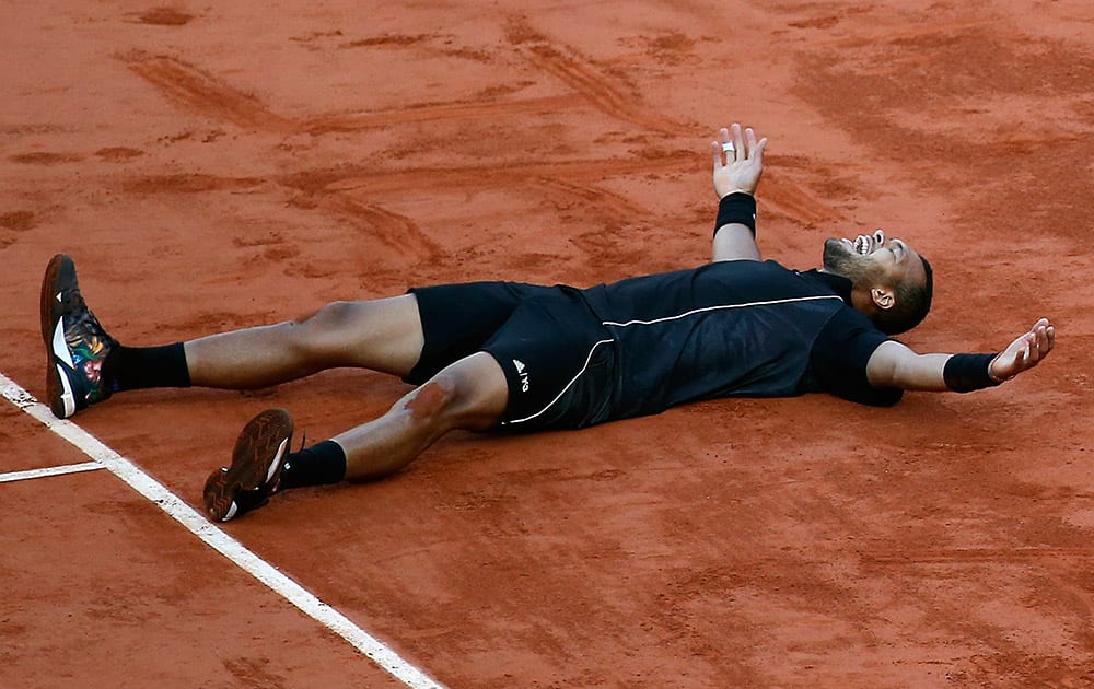 France's Jo-Wilfried Tsonga lies on the court after drawing 