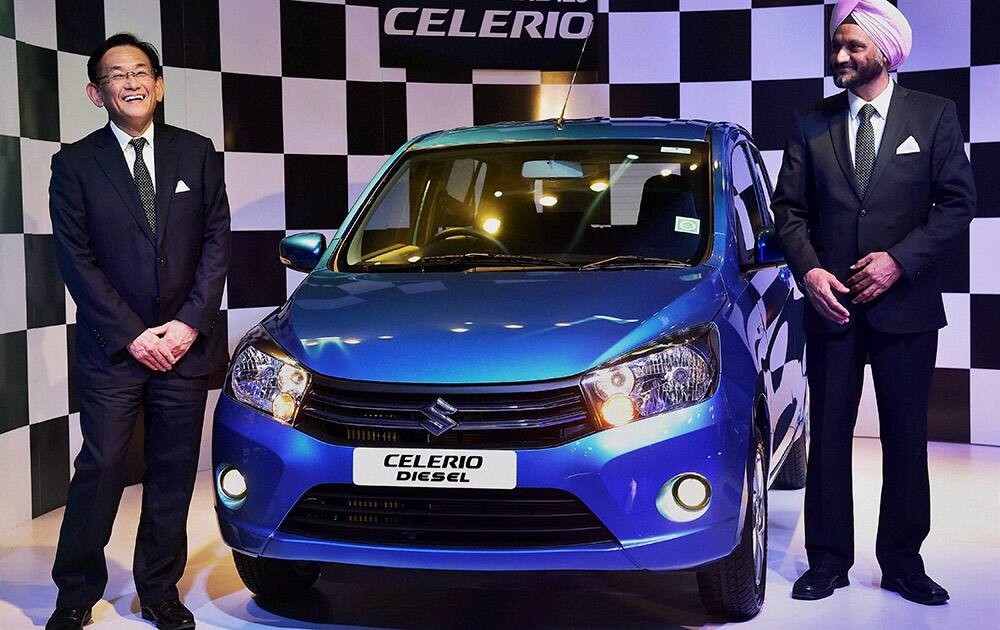 Kenichi Ayukawa (L), MD & CEO Maruti Suzuki with R S Kalsi, Executive Director, Marketing & Sales, Maruti Suzuki pose with companys Celerio diesel car during the global launch of Suzukis first diesel engine in New Delhi.