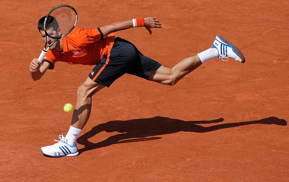 Serbia's Novak Djokovic returns in the quarterfinal match of the French Open tennis tournament against Spain's Rafael Nadal at the Roland Garros stadium, in Paris, France.