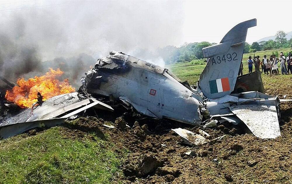 Crowd gather around an crashed advanced jet trainer in Baripada.