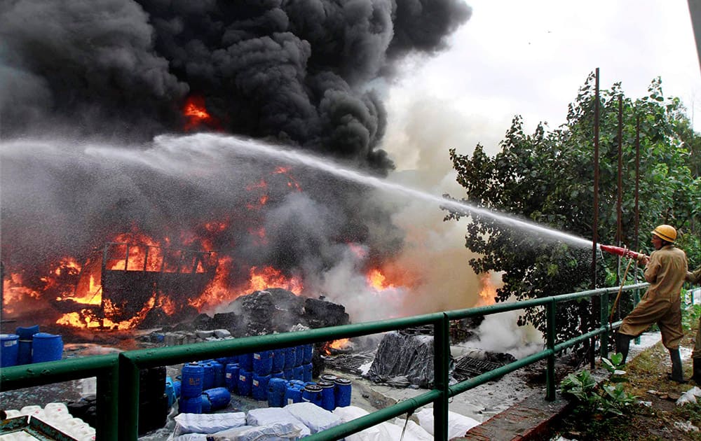 Firemen extinguishing fire after a major blaze broke out in Transport Nagar area near the Punjabi Bagh Metro station when an oil tanker parked there somehow caught fire.