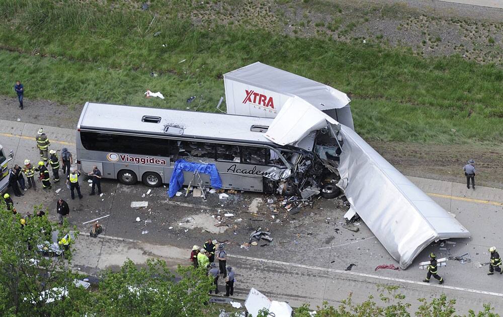 Authorities investigate the scene of a fatal collision between a tractor-trailer and a tour bus on Interstate 380 near Mount Pocono, Pa.