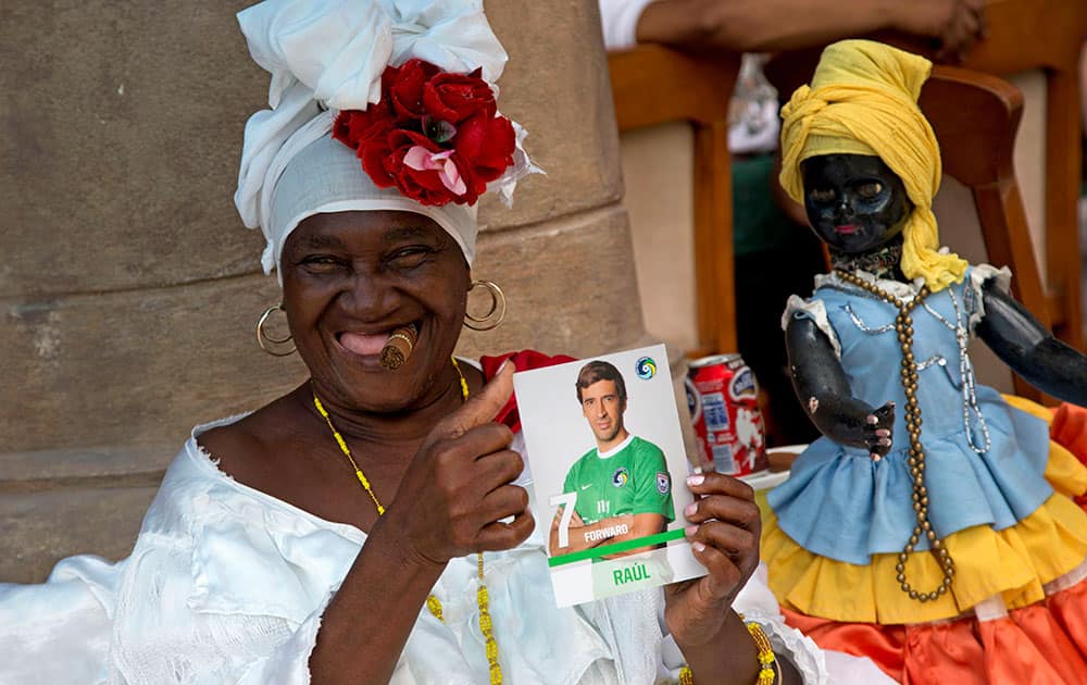 A palm reader shows a picture of New York Cosmos soccer player Raul Gonzalez in Havana, Cuba.