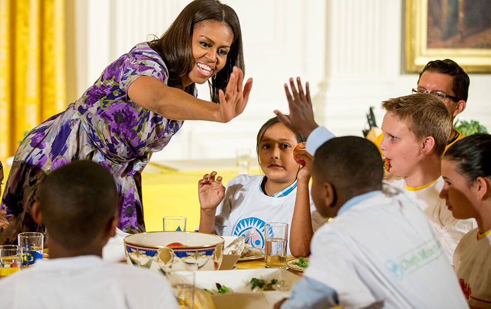 First lady Michelle Obama greets some of the children who participated in events with the 