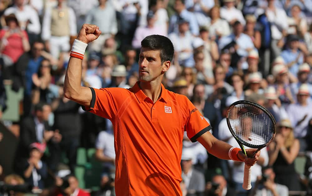 Serbia's Novak Djokovic celebrates winning the quarterfinal match of the French Open tennis tournament against Spain's Rafael Nadal in three sets, 7-5, 6-3, 6-1, at the Roland Garros stadium, in Paris, France.