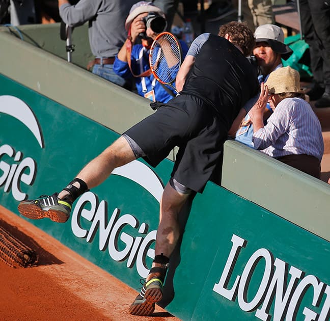 Britain's Andy Murray crashes into spectators in the quarterfinal match of the French Open tennis tournament against Spain's David Ferrer which Murray won in four sets 7-6 (7-4), 6-2, 5-7, 6-1, at the Roland Garros stadium, in Paris, France.