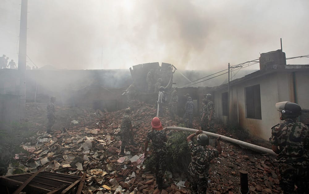 Nepalese firefighters extinguish a fire at Nepal Electricity Authority (NEA) distribution centre in Ratnapark, Nepal.