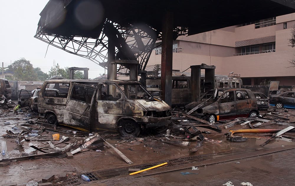 The remaining structure of a gas station after it exploded in Accra, Ghana. Flooding in Ghana's capital swept stored fuel into a nearby fire, setting off a huge explosion at a gas station that killed dozens of people and set alight neighboring buildings, authorities said Thursday. 