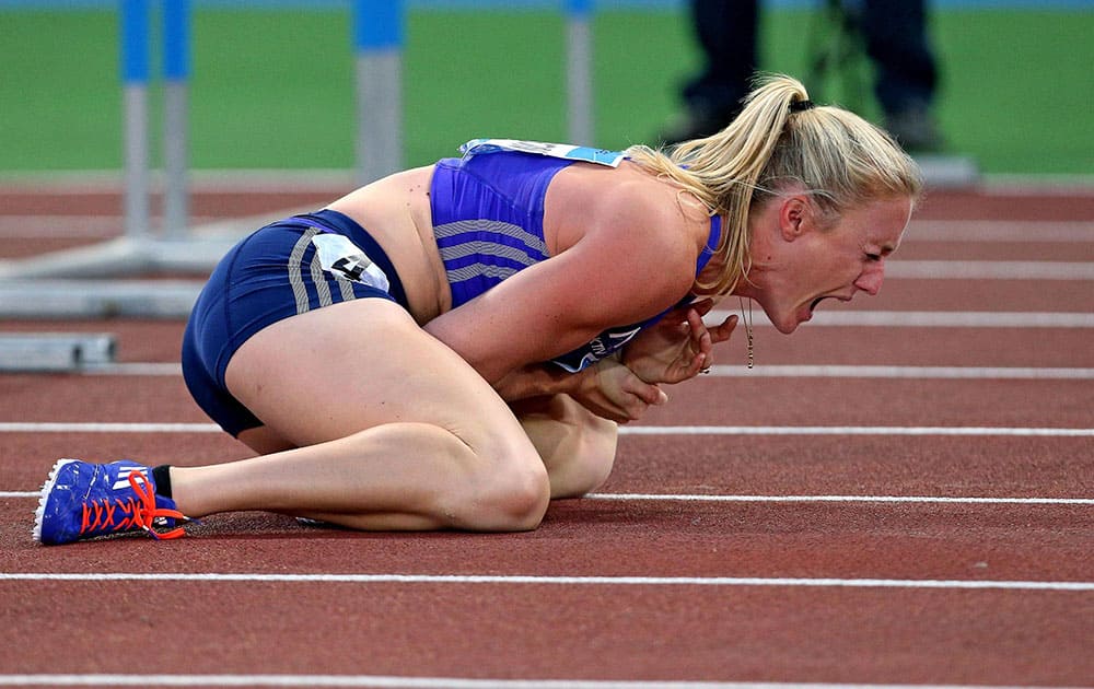 Sally Pearson shouts in pain after hitting an obstacle during the women's 100 hurdles event, at the Golden Gala IAAF athletic meeting, in Rome's Olympic stadium.