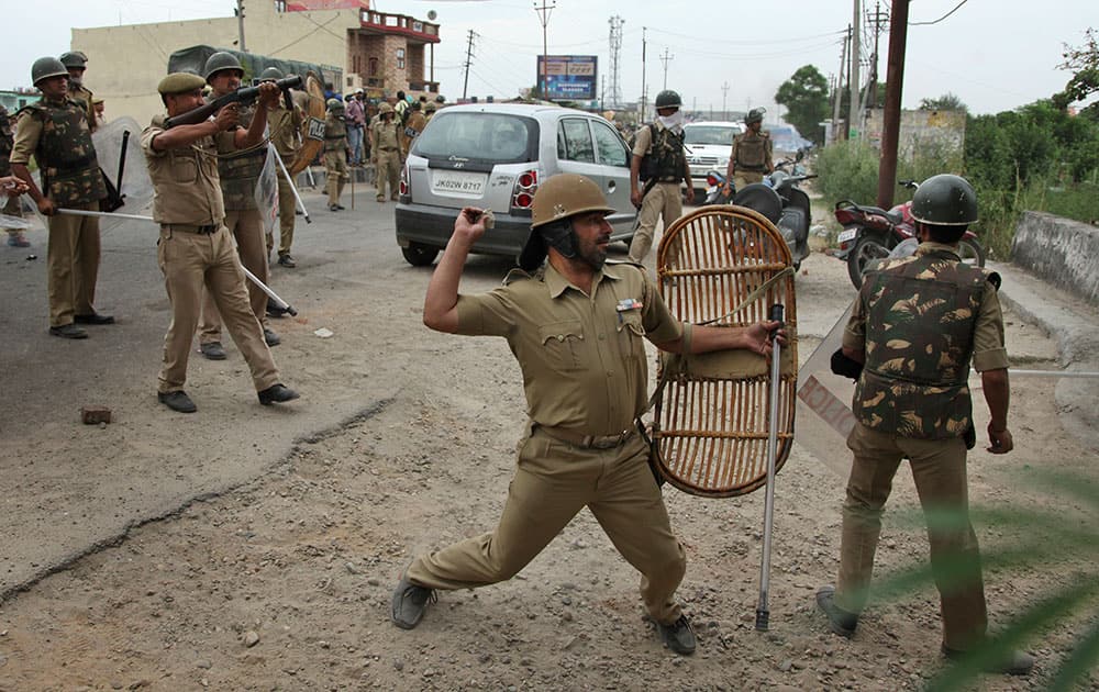 Police throw stones at Sikh protesters as they clash during a protest in Jammu, India. he protests triggered by the removal of posters of Sikh leader Jarnail Singh Bhindranwale by police yesterday left one protester killed and over a dozen others injured Thursday, according to local reports.