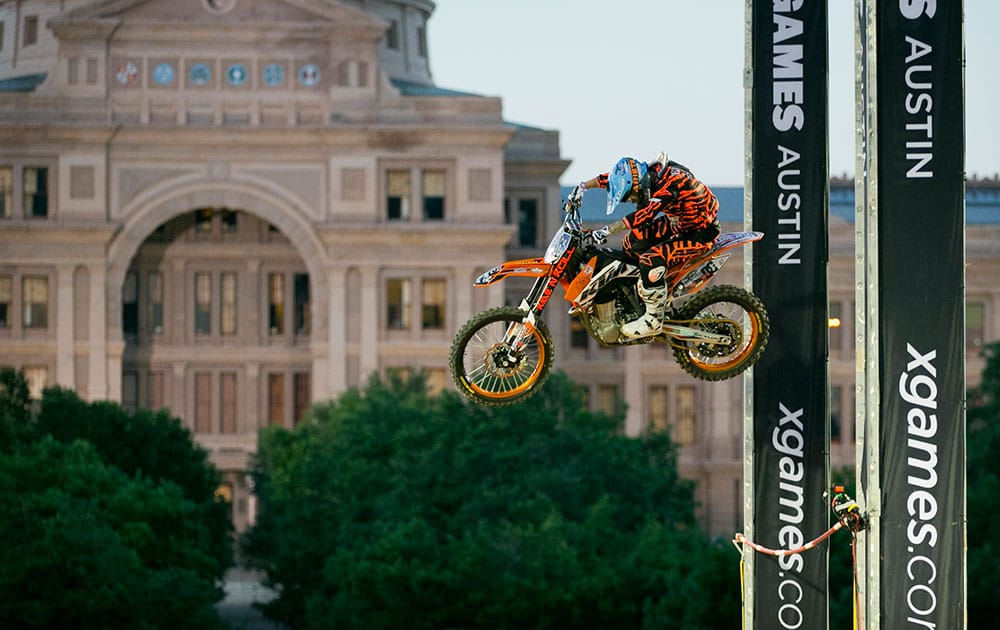 Massimo Bianconcini clears the bar in the X Games Moto X Step Up event in front of the Capitol in Austin, Texas.