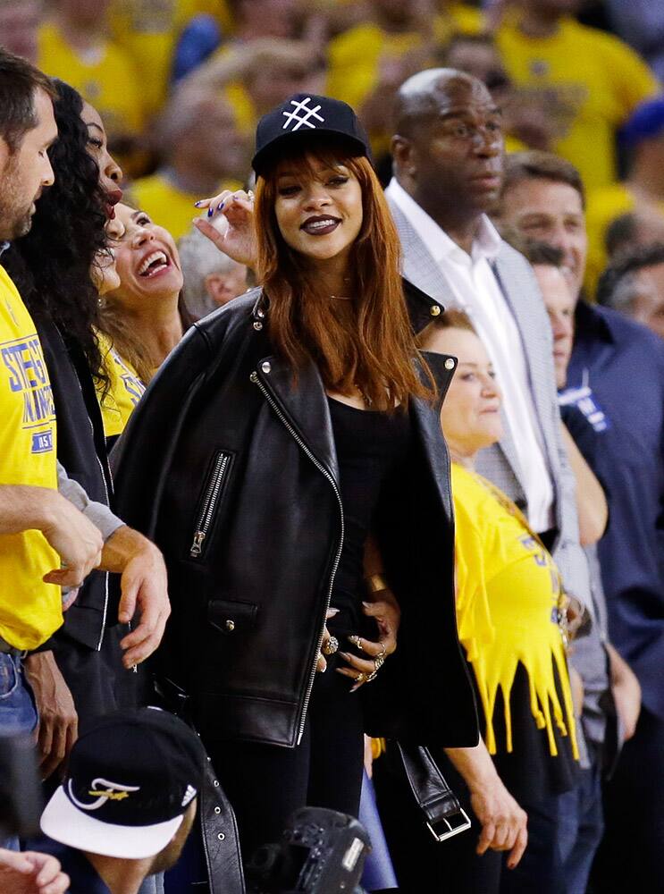 Musician Rihanna watches from the sideline during the second half of Game 1 of basketball's NBA Finals between the Golden State Warriors and the Cleveland Cavaliers in Oakland, Calif.