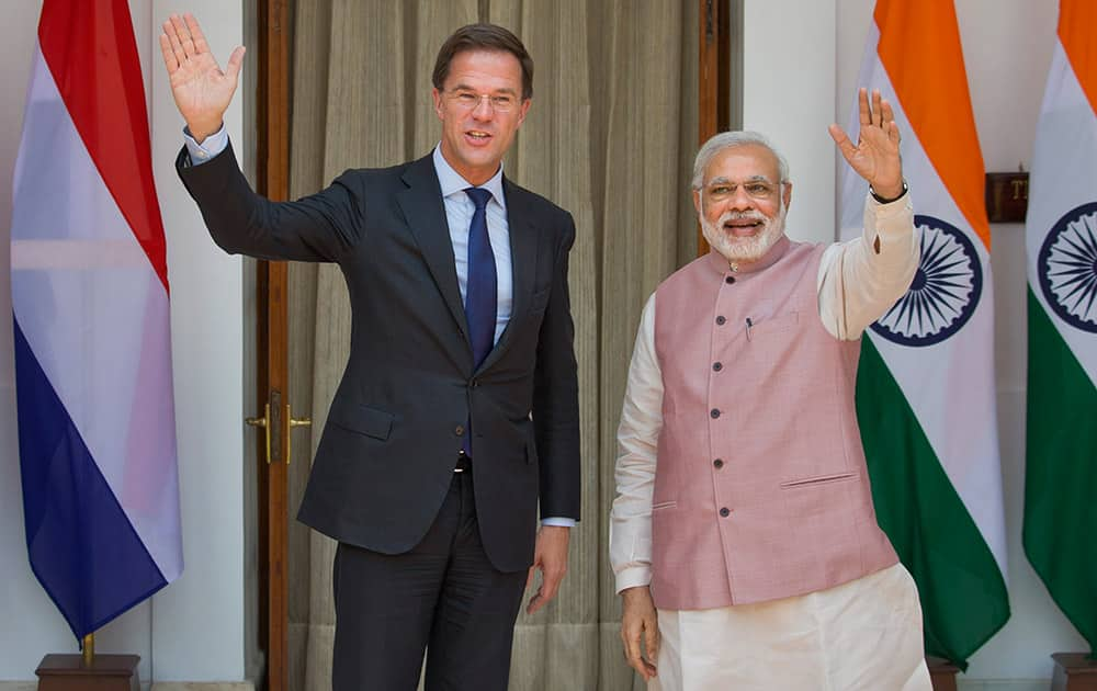 Prime Minister Narendra Modi and Netherlands Prime Minister Mark Rutte wave to the media before the start of their meeting in New Delhi. Rutte is on a three-day visit to India.