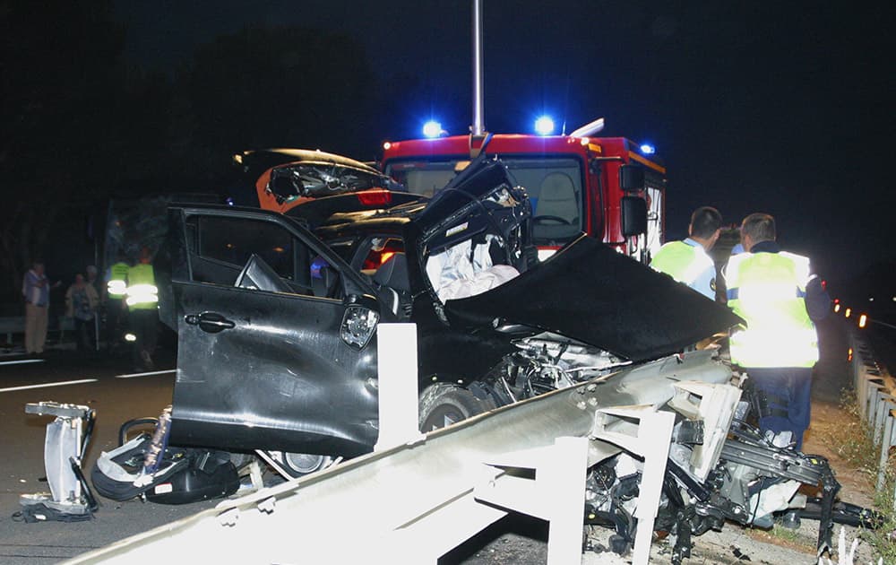 The wreckage of car belonging to rugby player Jerry Collins is pictured in the highway near Beziers, southern France. Former All Blacks flanker Jerry Collins and his partner died after their car was struck by a bus at a highway toll booth outside the southern French town of Beziers on Friday.