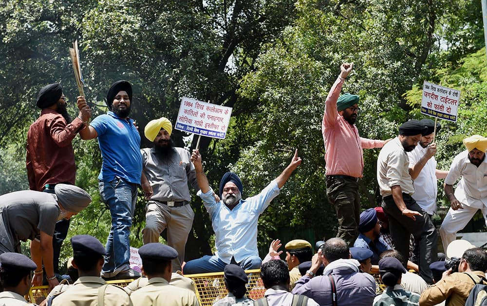 Sikh protesters shout slogans during a protest against Congress leaders over 1984 anti-Sikh riots in New Delhi.