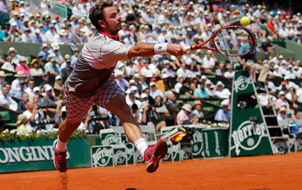 Switzerland's Stan Wawrinka returns the ball to France's Jo-Wilfried Tsonga during their semifinal match of the French Open tennis tournament at the Roland Garros stadium in Paris.