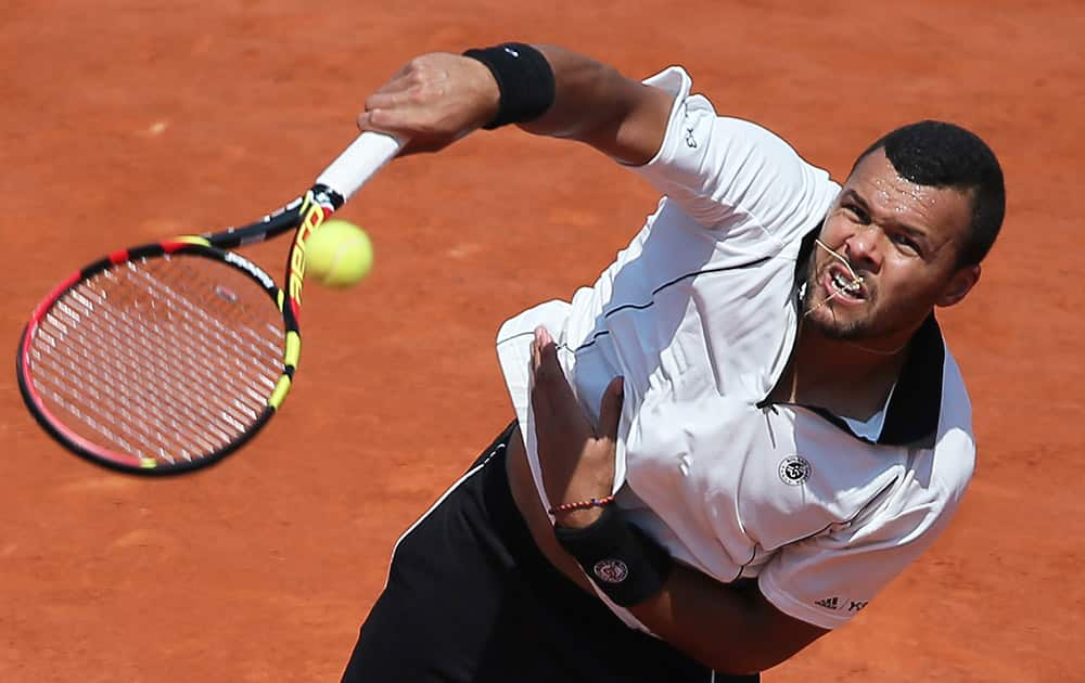 France's Jo-Wilfried Tsonga serves in the semifinal match of the French Open tennis tournament against Switzerland's Stan Wawrinka at the Roland Garros stadium, in Paris, France.