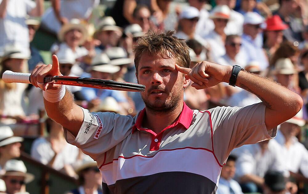 Switzerland's Stan Wawrinka celebrates winning the semifinal match of the French Open tennis tournament against France's Jo-Wilfried Tsonga in four sets 6-3, 6-7, 7-6, 6-4, at the Roland Garros stadium, in Paris, France.