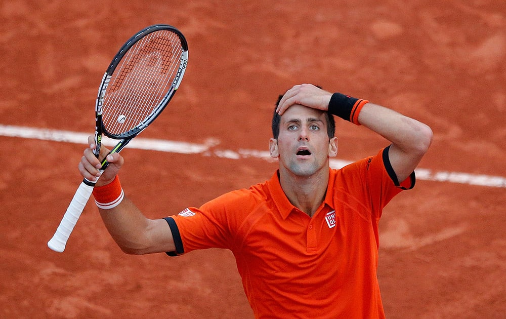 Serbia's Novak Djokovic reacts as he plays Britain's Andy Murray during their semifinal match of the French Open tennis tournament at the Roland Garros stadium in Paris, France.