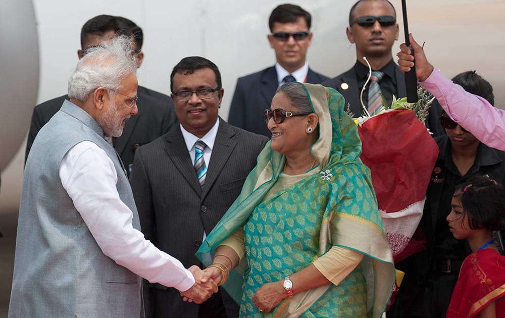 Bangladesh’s Prime Minister Sheikh Hasina shakes hand with Indian Prime Minister Narendra Modi upon his arrival at the Hazrat Shahjalal International airport in Dhaka, Bangladesh.