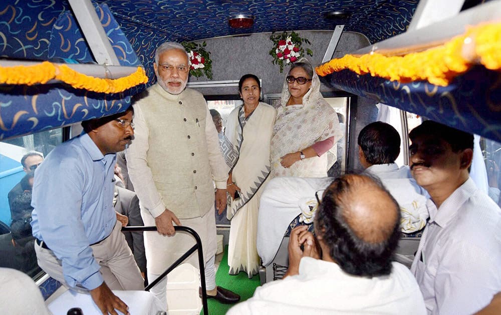 Prime Minister Narendra Modi, his Bangladeshi counterpart Sheikh Hasina and West Bengal Chief Minister Mamata Banerjee at the flag off ceremony of bus services between Bangladesh and India, in Dhaka.