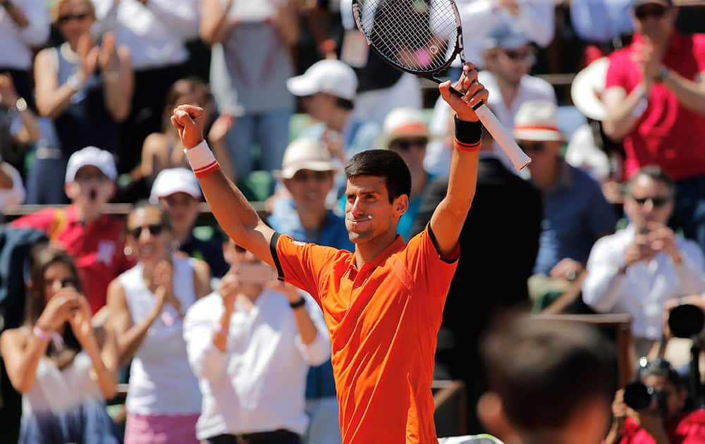 Serbia's Novak Djokovic raises his arms after defeating Britain's Andy Murray during their semifinal match of the French Open tennis tournament at the Roland Garros stadium in Paris.