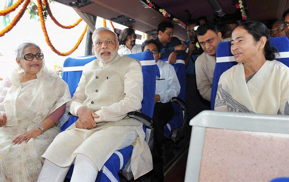 Prime Minister Narendra Modi, his Bangladeshi counterpart Sheikh Hasina and West Bengal Chief Minister Mamata Banerjee sitting in a bus at the flag off ceremony of bus services in Dhaka.